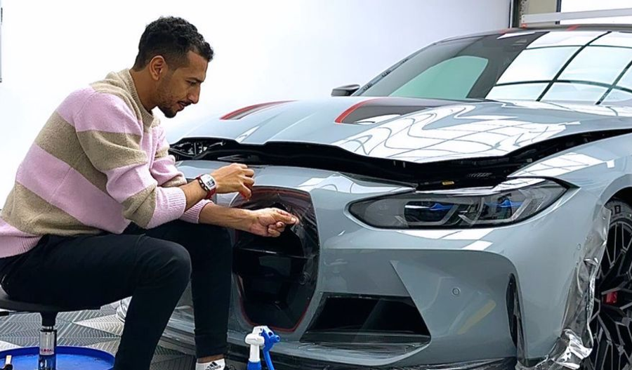 GenusCars expert installing PPF on BMW front bumper paint protection